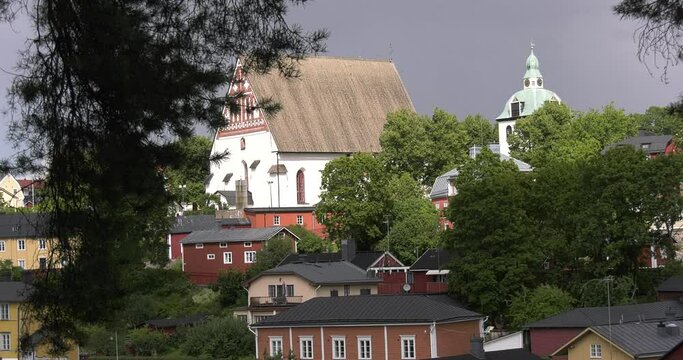 4K video of Porvoo vintage red wooden buildings, Porvoo Cathedral, yachts and boats in Porvoonjoki River near town center on sunny summer day in Finland, northern Europe