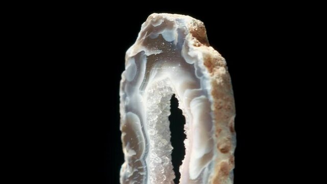 Agate with quartz. Agate rotates around its axis on a black background.