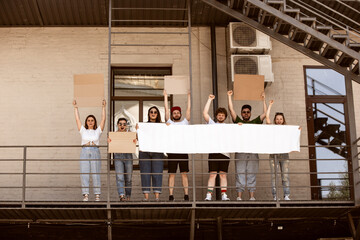 Diverse group of people protesting with blank sign. Protest against human rights, abuse of freedom,...