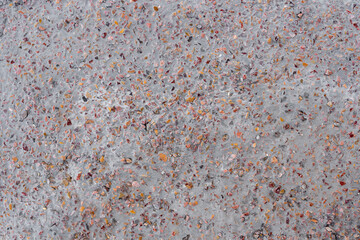 colored small rocky stones of natural origin in concrete, background for walls and wallpapers, distinguished texture of the material, natural color of the block