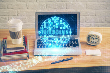 Multi exposure of blockchain theme hologram and table with computer background. Concept of bitcoin...