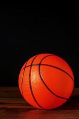 Basketball on a dark wooden floor, Dark background. Selective focus.