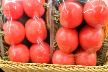 Photo of red tomatoes in packaging, ready for sale