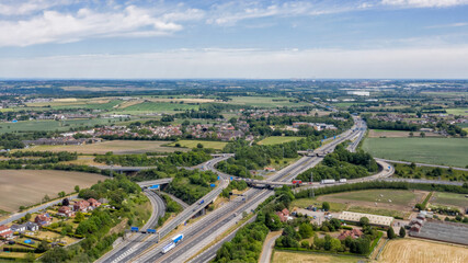 M62 Junction 29 and M1 junction 42 at lofthouse Interchange near Leeds West Yorkshire. Aerial photo in the sun. 