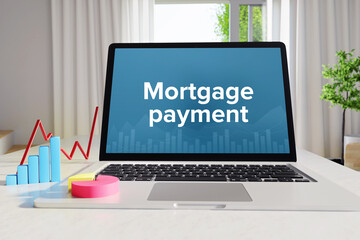 Mortgage payment – Statistics/Business. Laptop in the office with term on the Screen. Finance/Economy.