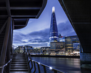 The Shard and London Hospital at dusk over the river thams near London Bridge showing moving clouds...