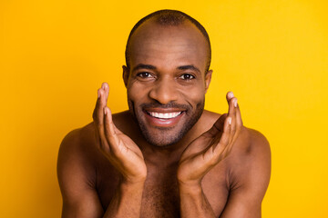 Close up photo of positive afro american guy wash water his face after shaving procedure enjoy...
