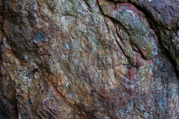 colored rocky stones of natural origin, background for walls and wallpapers, highlighted texture of the material, natural color blocks