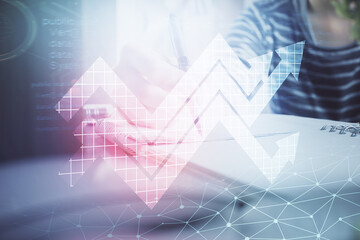 Blue arrow over woman's hands taking notes background. Concept of success. Double exposure