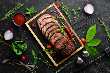 Baked veal and cheese roll with spices and rosemary. Top view. Rustic style.