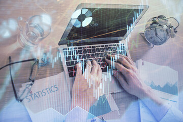Multi exposure of forex graph with man working on computer on background. Concept of market analysis.