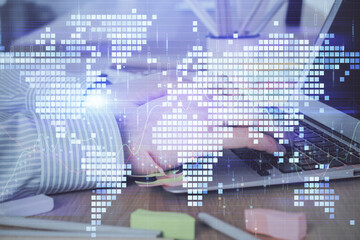 Multi exposure of businessman working on laptop on background. International business hologram in front. Concept of success.