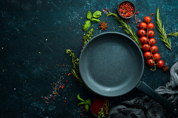 Culinary banner. Frying pan with vegetables on a black stone background. Top view. Rustic style. - obrazy, fototapety, plakaty