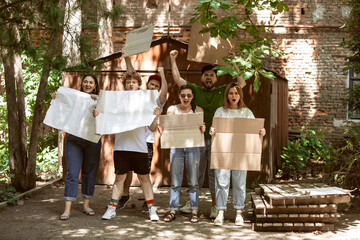 Diverse group of people protesting with blank sign. Protest against human rights, abuse of freedom,...