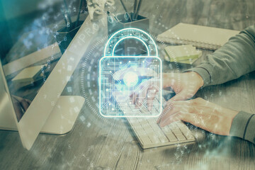 Multi exposure of lock icon with man working on computer on background. Concept of network protection.