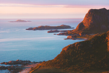 Pink sunset mountains and ocean landscape in Norway travel Vesteralen islands midnight sun aerial...