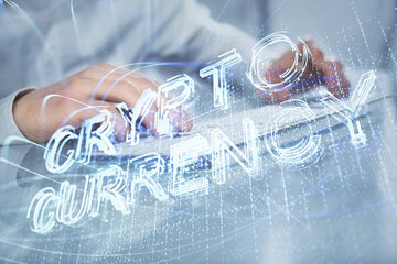 Crypto currency theme hologram with businessman working on computer on background. Concept of blockchain. Multi exposure.