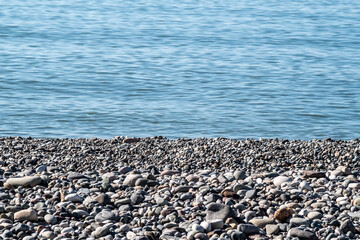 Abstract background of pebbles and sea. Day. Sunny. Georgia.