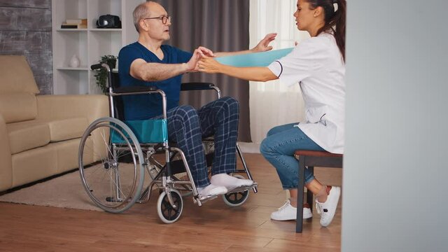 Disabled senior patient in wheelchair during rehabilitation with therapist. Disabled handicapped old person with social worker in recovery support therapy physiotherapy healthcare system nursing