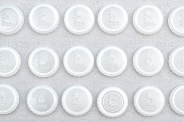 transparent white round caps on a gray background. pattern