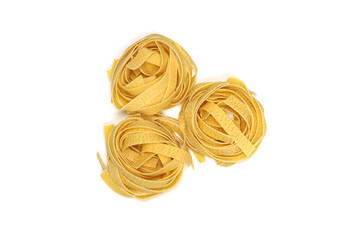 Italian pasta Fettuccine in form nest isolated on white background. Top view. Macaroni.