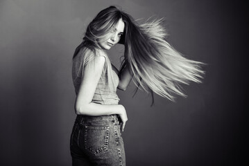 woman in gray looks back with flowing hair. Look straight. Free space for text © maxfotoadobe