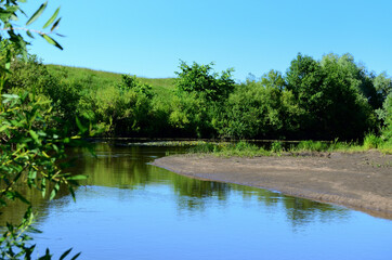Fototapeta na wymiar sandy river bank on a summer sunny day for rest