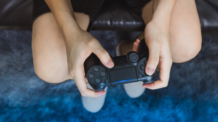 Man hand holding joystick while playing the game.