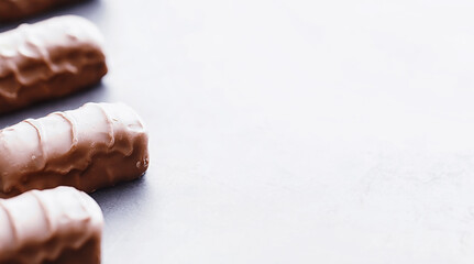 Chocolate bars on a black background in backlight. Chocolate with filling. Sweet sweets for snack and tea.