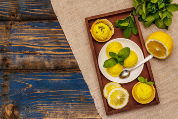 Lemon ice cream with mint. Refreshing summer dessert, ripe fruit, fragrant leaves