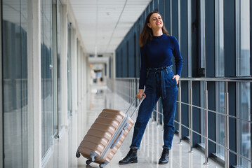 Pretty young female passenger at the airport (shallow DOF; color toned image)