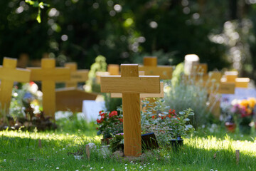 wooden crosses and flower decorations on a Potter's field in germany