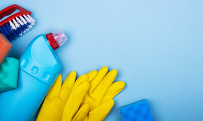 Home office apartment cleaning kit on blue background with space for text, top view