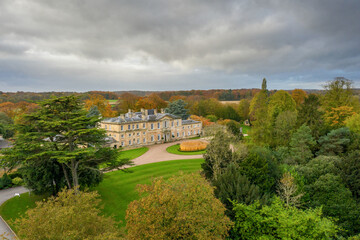 Fototapeta na wymiar Bowcliffe Hall Yorkshire stately home, wedding venue and offices close to the A1, York, Leeds and Bramham Park. Drone photo showing the front of the main building and trees on an autumn day