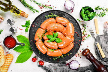 Boiled pork sausages with rosemary and spices. Top view. Rustic style.