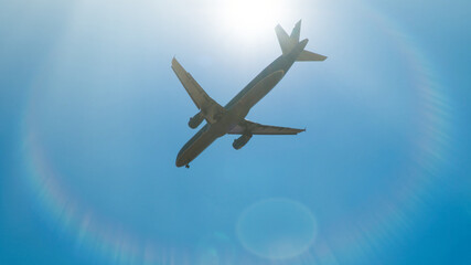 Commercial airplane jetliner flying in beautiful blue sky. Concept of travel and business.