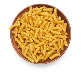 raw fusilli pasta in a brown clay plate isolated on white background