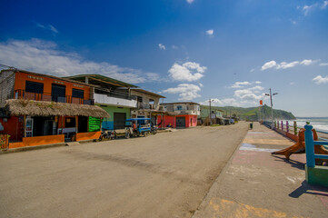MANABI, ECUADOR - JUNE 4, 2012: Stoned pavement road in the coast, surrounded with abundat vegetation in a sunny day in the Ecuadorian coasts