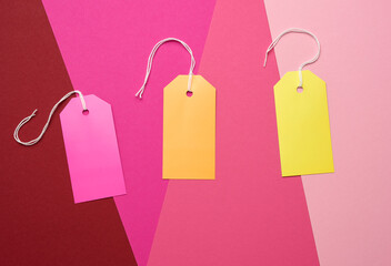 paper rectangular tags on a rope on a colored background