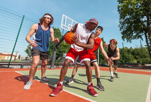 Male Basketball Team Training For Championship At Outdoor Court