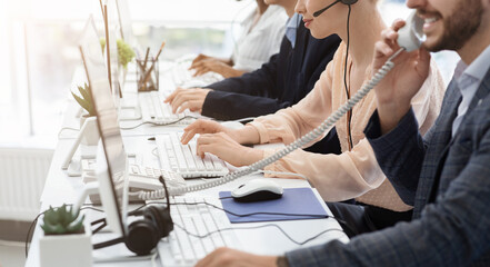 Closeup view of customer support operators working at call centre, copy space