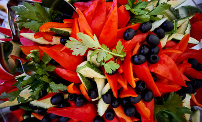 closeup pieces of pepper and black olives 