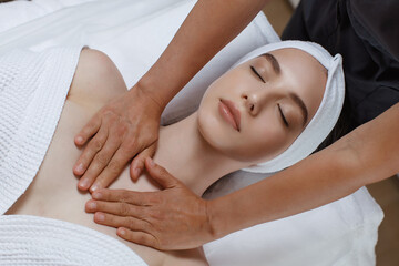 Fototapeta na wymiar Beautiful young woman relaxing with hand massage
