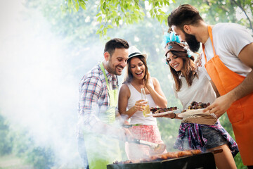 Friends having fun in nature doing bbq