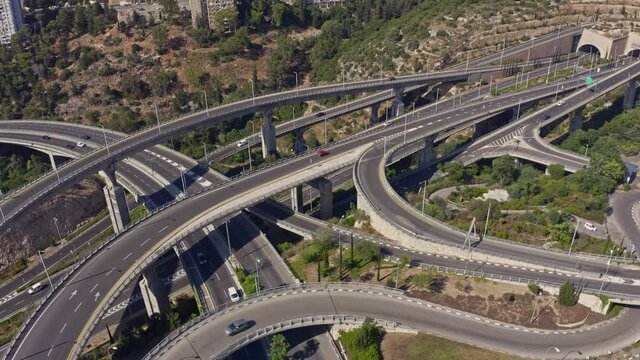 Huge highway road interchange near the Haifa transportation underground caves, aerial drone view 4k