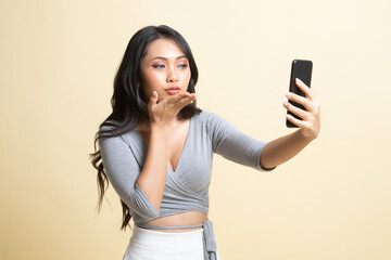 Naklejka premium Young Asian woman with mobile phone.