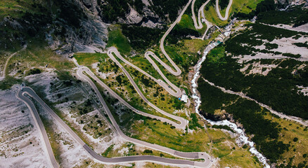Bird's eye view of famous Stelvio Pass mountains serpentine way. Top view of scenic curvy hairpins...