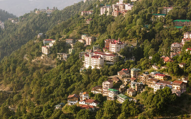 Naklejka premium A view of the hotels and the houses spread around the forested slopes in the Himalayan hill station.