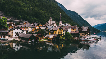 Fototapeta na wymiar Scenery aerial view of famous Hallstatt town on lake shore in mountains. Salzkammergut resort under the protection of UNESCO situated Hallstätter See, Alpine village in Austria