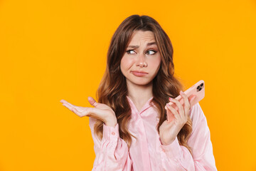 Image of nice displeased woman holding copyspace and using mobile phone